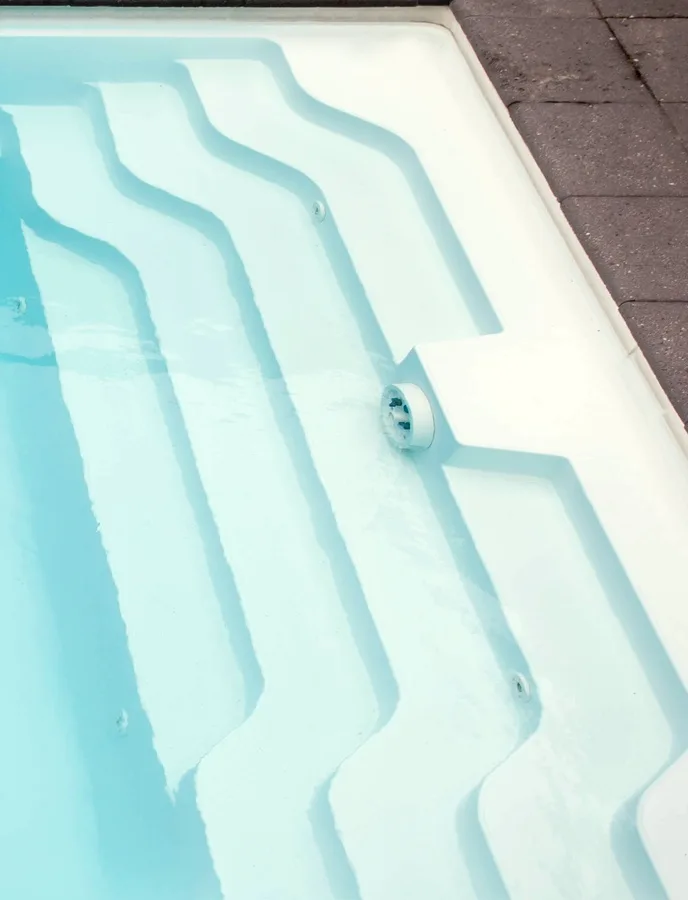 Crystal-clear pool water and steps, kept pristine by Picture Perfect Pools