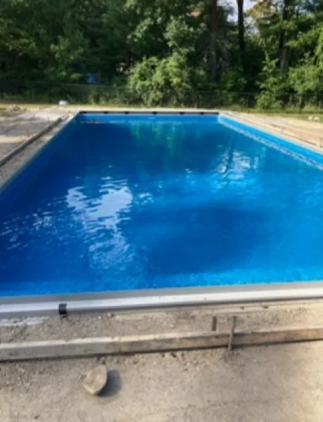 Same backyard pool after cleaning, water clear and blue