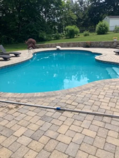 Same paver-patio pool after cleaning, water clear and blue