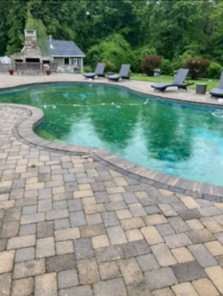 Paver-patio pool before cleaning, water green with algae