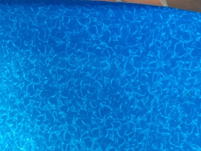 Close-up texture of clear, rippling pool water