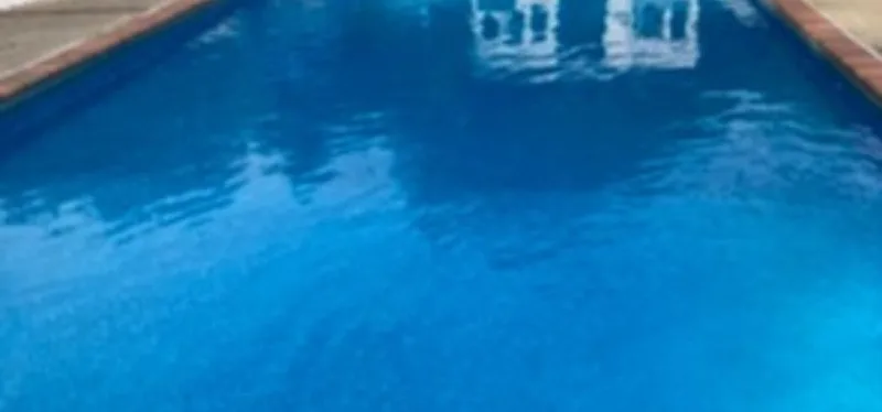A pristine backyard swimming pool, ready for opening day